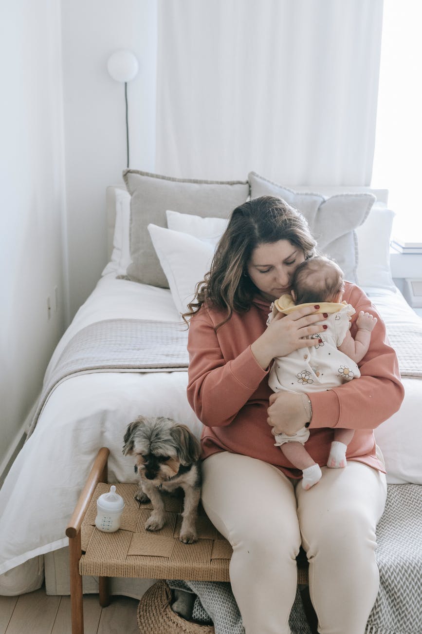 loving woman with baby and dog