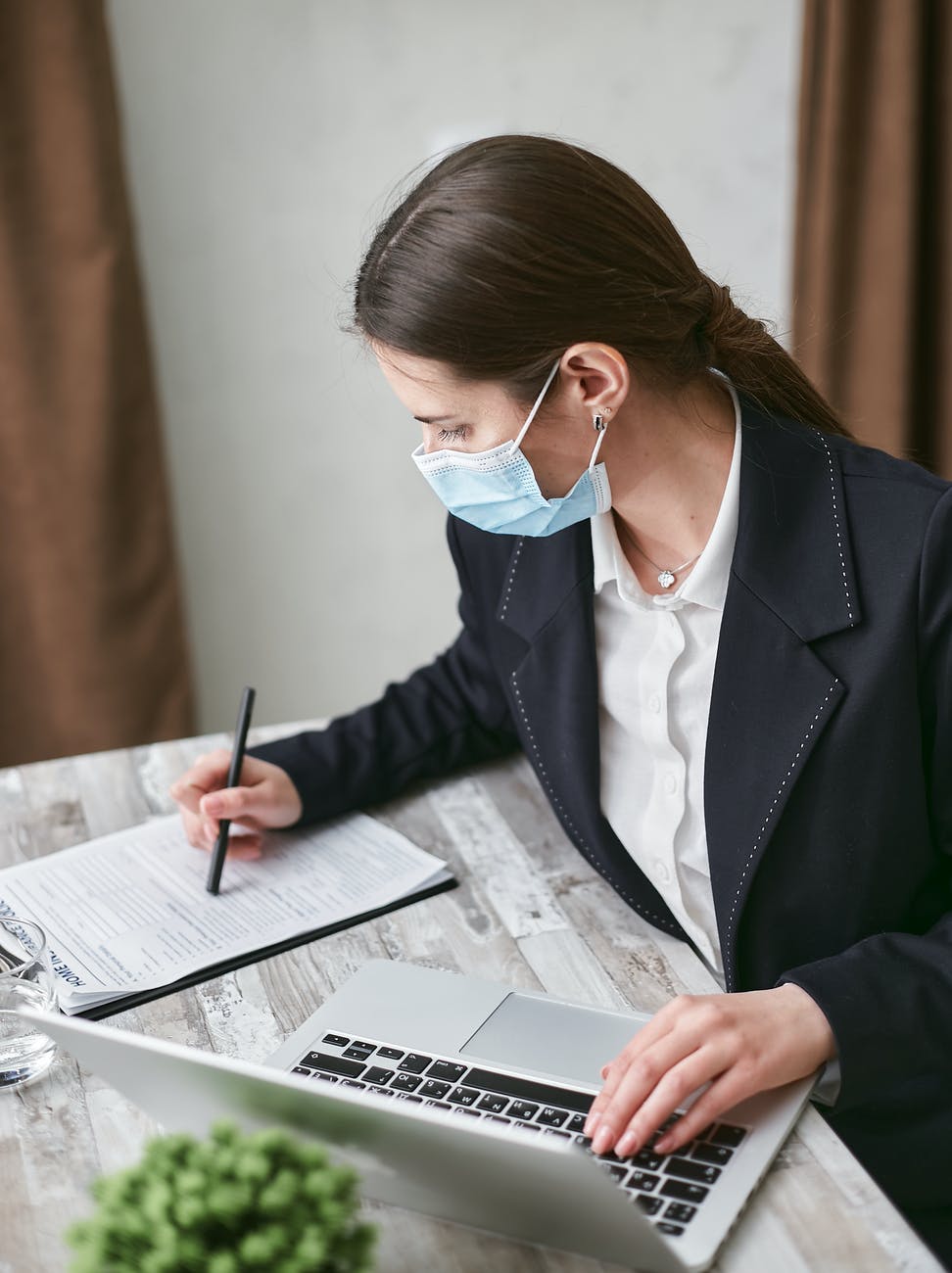 woman in black blazer using a laptop